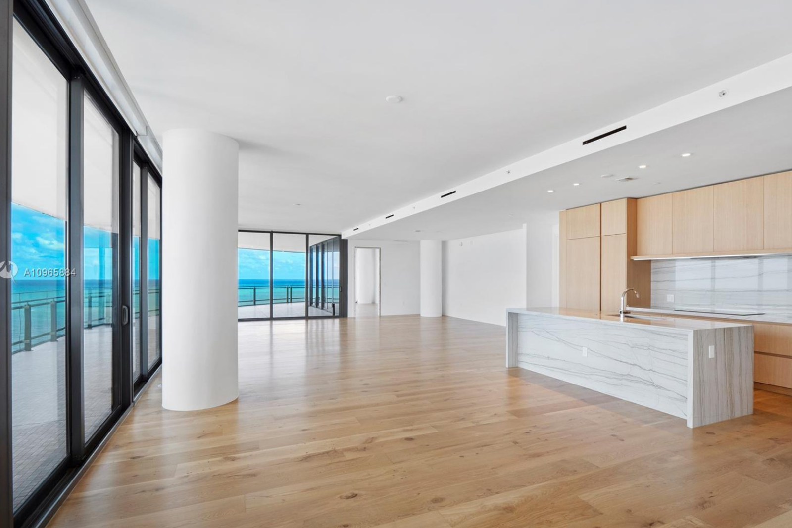 Image of large room with glass to wall ceilings, and stone counter top at 1501 Collins ave