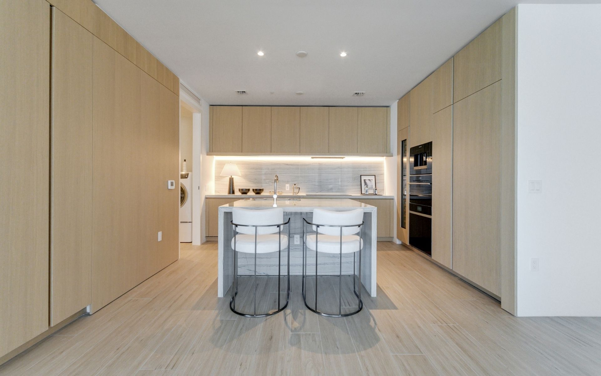 dining room table and kitchen inside 87 park residences