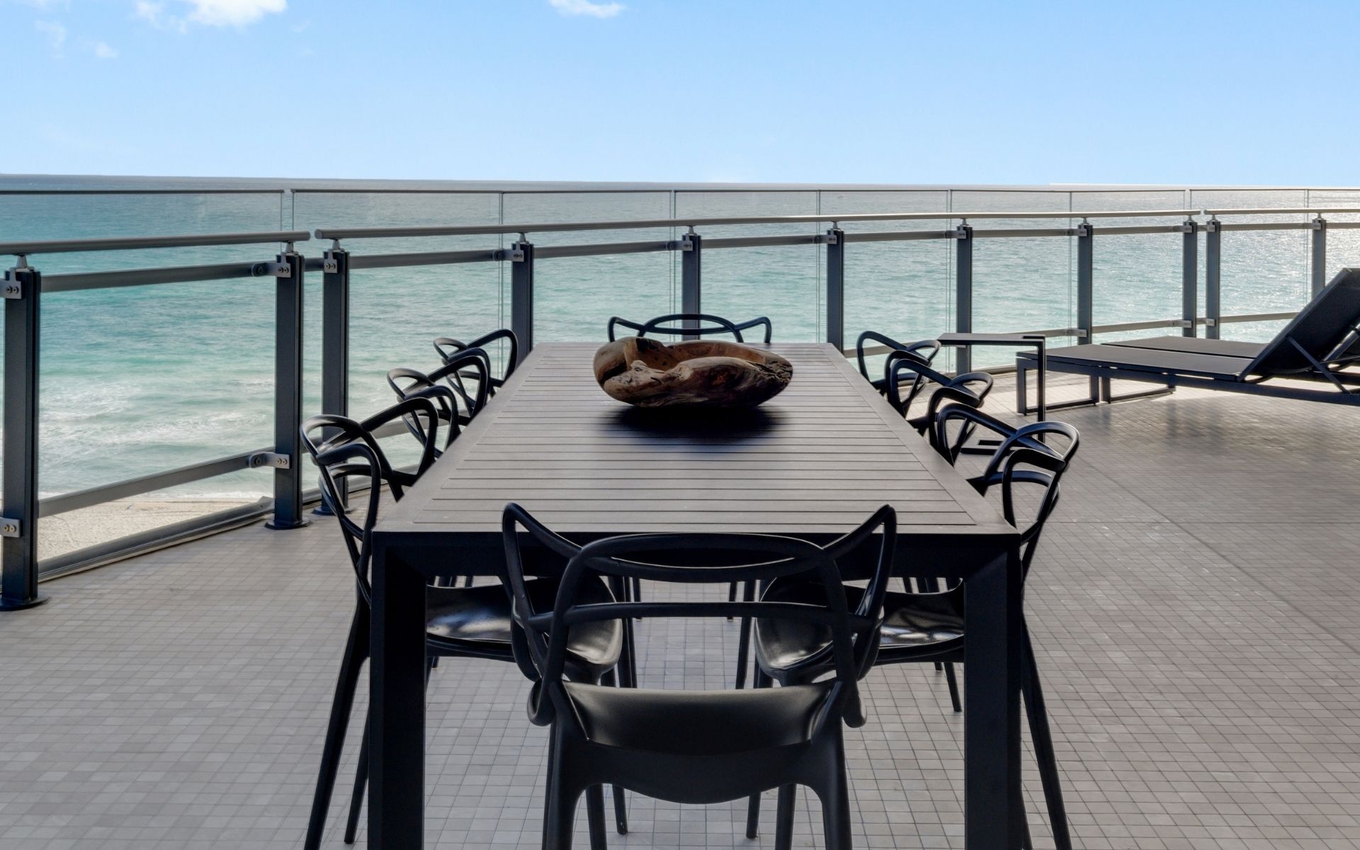 black dining room table on outside deck at 87 park residences