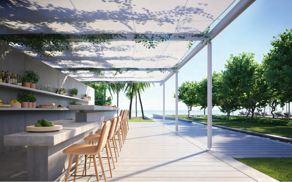 an outdoor deck with stone countertops and wooden chairs facing Miami beach